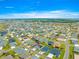 Community aerial view showcasing numerous homes in a well-designed neighborhood and surrounding landscapes at 907 Trifu Ter, The Villages, FL 32163