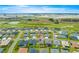 An aerial shot reveals the home's location within a community near a golf course and several tranquil ponds at 907 Trifu Ter, The Villages, FL 32163
