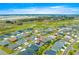 Aerial view showcases a home in a well-planned community near a lush golf course and picturesque ponds at 907 Trifu Ter, The Villages, FL 32163