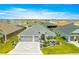 An aerial view of a lovely single-Gathering home with a well-kept lawn, paver driveway, and two-car garage in a residential area at 907 Trifu Ter, The Villages, FL 32163