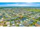 From above, this home is nestled within a residential area, conveniently located near a golf course and lush greenery at 907 Trifu Ter, The Villages, FL 32163