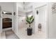 This primary bathroom is designed with double sinks, dark cabinets, decor and a large shower, adjoined to bedroom at 907 Trifu Ter, The Villages, FL 32163