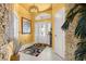 Charming foyer featuring decorative stone wall and arched window above the door at 907 Trifu Ter, The Villages, FL 32163