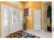 Inviting foyer with decorative stone wall, high ceilings, and a charming statue at 907 Trifu Ter, The Villages, FL 32163