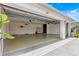 A spacious and well-lit two-car garage with epoxy floors and white walls, offering plenty of room for storage and vehicles at 907 Trifu Ter, The Villages, FL 32163