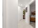 Hallway leading to bedroom and bathroom with modern finishes and neutral color palette at 907 Trifu Ter, The Villages, FL 32163