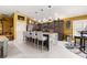 Stylish kitchen showcasing stainless steel appliances, a large island with seating, and modern lighting at 907 Trifu Ter, The Villages, FL 32163