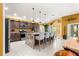 Updated kitchen with stainless steel appliances, a large island with seating, and recessed lighting at 907 Trifu Ter, The Villages, FL 32163
