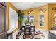 Eat-in kitchen area with plantation shutters, breakfast table, and sliding glass door to patio at 907 Trifu Ter, The Villages, FL 32163