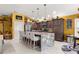Modern kitchen featuring a granite island with seating, stainless steel appliances and recessed lighting at 907 Trifu Ter, The Villages, FL 32163