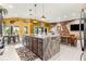 Spacious island kitchen, showcasing granite counters, eat-in bar, and stainless steel appliances at 907 Trifu Ter, The Villages, FL 32163