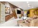 Open-concept living room featuring stone accent wall and seamless flow into the island kitchen at 907 Trifu Ter, The Villages, FL 32163