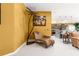 Cozy seating area with unique chair, modern decor, and view into kitchen at 907 Trifu Ter, The Villages, FL 32163