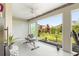 Bright sunroom featuring exercise equipment, large windows offering picturesque backyard views at 907 Trifu Ter, The Villages, FL 32163