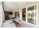 Spacious sunroom with exercise equipment, comfortable seating, and picturesque outdoor views at 907 Trifu Ter, The Villages, FL 32163