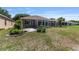 Spacious backyard with a patio, landscaping, green grass, and a glimpse of the home's exterior at 9649 Sw 90Th St, Ocala, FL 34481