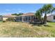 Backyard with a screened-in patio, lawn, and palm tree at 9649 Sw 90Th St, Ocala, FL 34481