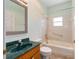 The bathroom has a green countertop, a shower-tub combo, and tile flooring at 9649 Sw 90Th St, Ocala, FL 34481