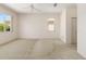 Bright and spacious bedroom with neutral walls and carpet, large windows, and a ceiling fan at 9649 Sw 90Th St, Ocala, FL 34481