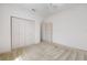 A bedroom features a ceiling fan, plush carpeting, and a closet for storage at 9649 Sw 90Th St, Ocala, FL 34481
