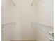 A walk-in closet features white wire shelving for optimal storage and organization space at 9649 Sw 90Th St, Ocala, FL 34481