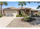 Home exterior featuring a lush lawn, attractive stone landscaping, and a large driveway at 9649 Sw 90Th St, Ocala, FL 34481
