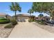 Charming home exterior with a well-manicured lawn, stone landscaping, and a spacious driveway at 9649 Sw 90Th St, Ocala, FL 34481