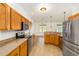 Spacious kitchen with stainless steel appliances, wood cabinetry, and an open view of the breakfast nook at 9649 Sw 90Th St, Ocala, FL 34481