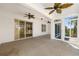 Covered patio featuring neutral carpeting, ceiling fans, and sliding glass doors to the backyard at 9649 Sw 90Th St, Ocala, FL 34481