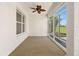 The sunroom features scenic views, a ceiling fan, and natural light at 9649 Sw 90Th St, Ocala, FL 34481
