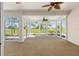 Spacious sunroom with large windows offering panoramic views of the golf course at 9649 Sw 90Th St, Ocala, FL 34481