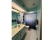 Blue bathroom with modern fixtures, ample lighting, and a clean, fresh feel at 9850 Sw 191St Ave, Dunnellon, FL 34432