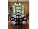 Bright dining room with a large bay window and classic wooden table at 9850 Sw 191St Ave, Dunnellon, FL 34432