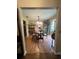 Cozy dining room with hardwood floors and an adjacent kitchen view at 9850 Sw 191St Ave, Dunnellon, FL 34432