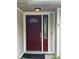 Elegant red front door with decorative glass panels and stylish hardware at 9850 Sw 191St Ave, Dunnellon, FL 34432