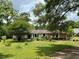 Charming single-story home surrounded by lush greenery and mature trees on a sun-drenched lot at 9850 Sw 191St Ave, Dunnellon, FL 34432