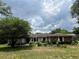 Charming single-story home with stone accents and mature landscaping in a well-maintained front yard at 9850 Sw 191St Ave, Dunnellon, FL 34432