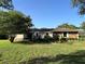 Charming single-story home with lush landscaping and a well-maintained lawn at 9850 Sw 191St Ave, Dunnellon, FL 34432