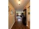 Inviting hallway with hardwood floors that leads into a bright and open living space at 9850 Sw 191St Ave, Dunnellon, FL 34432