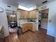 Kitchen featuring wood cabinets and view to dining area, creating a connected space at 9850 Sw 191St Ave, Dunnellon, FL 34432