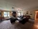 Spacious living room featuring a stone fireplace and comfortable leather seating at 9850 Sw 191St Ave, Dunnellon, FL 34432