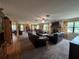 Expansive living room with a fireplace, large windows, and ample seating area at 9850 Sw 191St Ave, Dunnellon, FL 34432