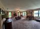 Open-concept living area with a dining table, piano, and plenty of natural light at 9850 Sw 191St Ave, Dunnellon, FL 34432