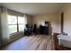 Office space with large window, hardwood floors, black desk, and office chair at 9850 Sw 191St Ave, Dunnellon, FL 34432