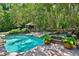 Tranquil backyard oasis featuring a swimming pool, spa, gazebo, and lush greenery at 1300 Sw 43Rd Pl, Ocala, FL 34471