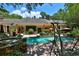 Beautiful backyard with a sparkling pool, manicured landscaping, and lounge areas at 1300 Sw 43Rd Pl, Ocala, FL 34471