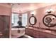 Serene bathroom with double sinks, granite counters, a soaking tub, and a glass block window at 1300 Sw 43Rd Pl, Ocala, FL 34471