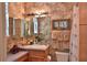 Elegant bathroom with granite countertops, ornate mirrors, and a shower featuring a decorative palm tree shower curtain at 1300 Sw 43Rd Pl, Ocala, FL 34471