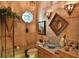 Unique bathroom with decorative mirror, sconces, textured walls, and a vessel sink at 1300 Sw 43Rd Pl, Ocala, FL 34471