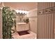 Cozy bathroom with neutral tiling, ample vanity space, and a large bamboo plant, creating a serene atmosphere at 1300 Sw 43Rd Pl, Ocala, FL 34471
